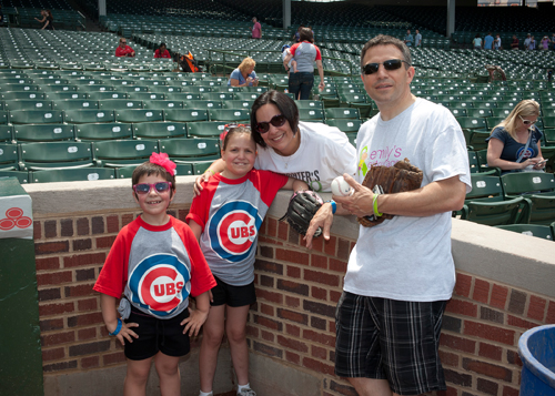 Emily Beazley, a 10-year-old battling Stage III T-Cell Lymphoblastic Non-Hodgkins Lymphoma, enjoyed time with her family playing catch and running bases on the field.