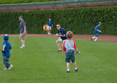 Carter and his dad play catch in the outfield.