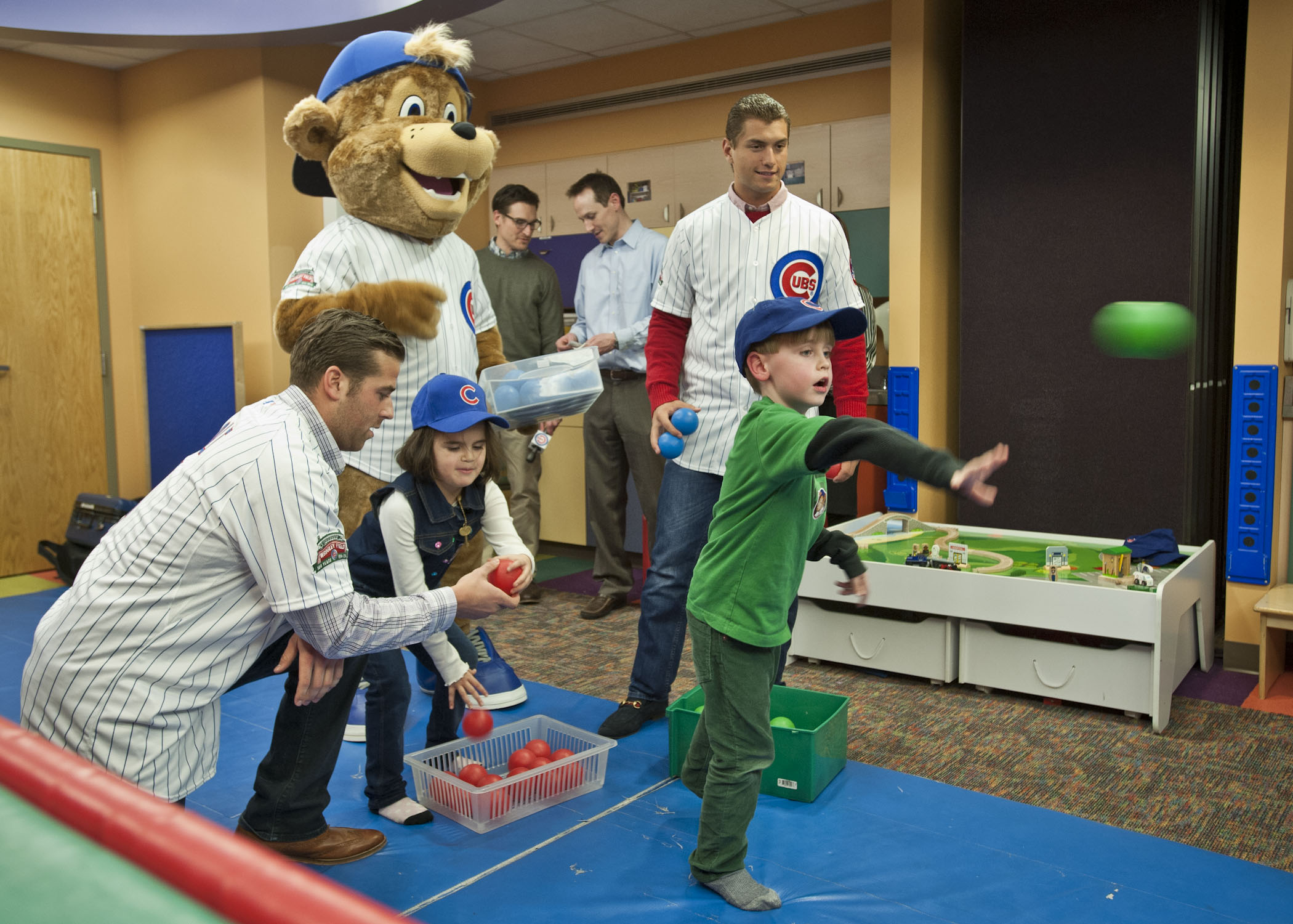 The Chicago Cubs’ new mascot, Clark, and prospects Mike Olt and Albert Almora play a ball toss game with the kids.