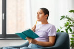 A woman planning her New Year's resolutions.