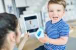 A parent and child on a telehealth doctor's appointment.