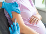 A pregnant woman gets a vaccination.