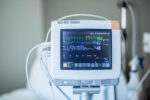 An EKG monitor displays a patient's vitals.