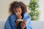 Woman has a fever because she has the seasonal flu.