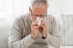 Man is sick with seasonal respiratory illness.