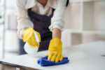 Woman cleaning table at home.