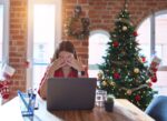A woman stressed out at work around Christmas time.