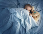 A child having sleep problems in bed at night.