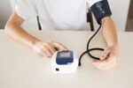 A teenager taking his blood pressure to see if he has high reading due to hypertension.