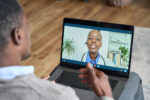 A virtual telehealth doctor's appointment with a patient at home.