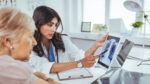 Doctor and patient looking at a lung cancer x-ray.