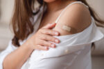 A young woman receives the HPV vaccine to prevent cancer.