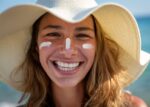 A woman has applied sunscreen to her face.