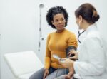 A woman getting her blood pressure checked to see if she has cardiovascular-kidney-metabolic syndrome (CKM).