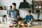 A family cooking together in the kitchen as a resolution to eat healthier