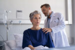 A doctor listening to a patient's breathing after a bronchoscopic lung volume reduction to treat copd.