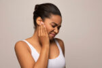 A woman has ear popping sensation.