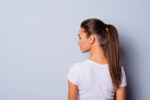 A woman wearing a ponytail.