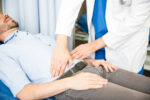 A man with a chronic condition visits the doctor for digestive health issues.