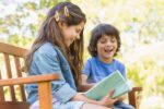 Children keeping up with summer reading outside.