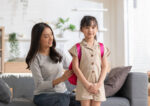 A mom gets her child ready for first day of school.