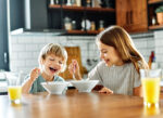 Children eating breakfast before school.