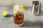 A dirty soda on a counter with cream and lime.