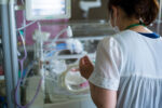 A NICU parent reading to NICU baby can improve the child's language development.