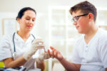 A child with diabetes visits school nurse to get blood sugar levels checked.