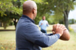 A family plays a friendly game of backyard football on Thanksgiving. This is one of the common reasons for injuries on Thanksgiving.
