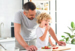 A dad slices strawberries in half to prevent son from choking on one.
