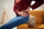 A young woman with hip pain who may benefit from hip replacement surgery at a younger age.