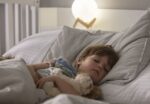 A sound machine helps young child sleep.