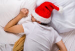 A person who is tired during Christmas time and needs to prioritize quality sleep.