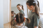 Young children in front of a mirror. Kids are at risk of body image issues.