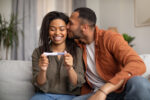 A couple who has been struggling with their fertility celebrates a positive pregnancy test.