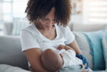 A woman breastfeeding a possibly tongue-tied baby.
