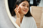 A woman using cystic acne treatment.