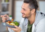 A man eating healthy to lower his cholesterol.