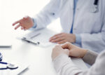 A patient asking their doctor questions after new medical diagnosis.