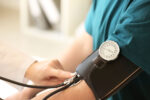 A person with hypertension receiving a blood pressure reading.