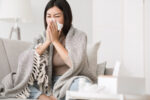 A woman not following the rules of safely blowing her nose.