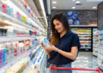 A woman looking for gluten on her grocery food product.