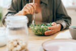 A woman deciding if she should eat small or large meals.