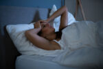 A woman is sleep deprived which weakens her immune system and increases inflammation.