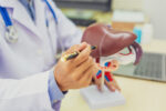 A doctor showing how fatty liver occurs.