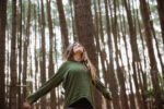 A woman forest bathing.