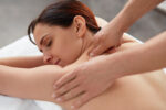 A woman receiving the health benefits of massage therapy.
