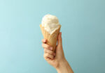 A person holding an ice cream cone who has lactose intolerance.