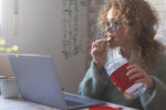 A woman emotional eating because she is stressed from work.